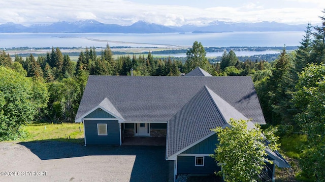 drone / aerial view with a water and mountain view