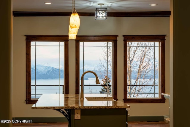 interior details featuring a sink, ornamental molding, a water and mountain view, and recessed lighting