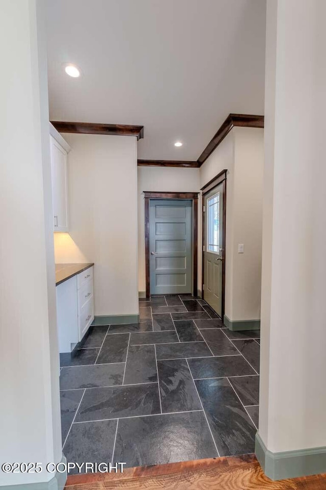 interior space featuring ornamental molding, recessed lighting, and baseboards