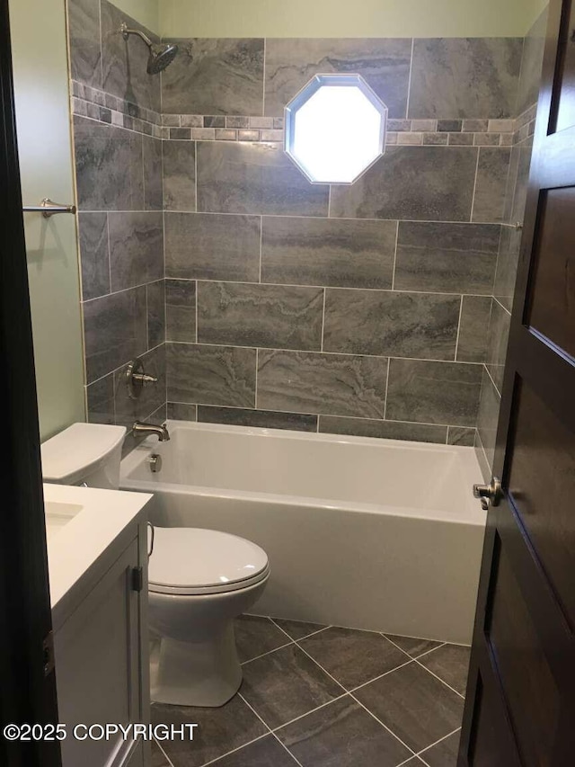 bathroom with tile patterned flooring, shower / bath combination, vanity, and toilet