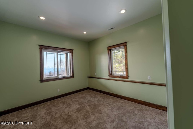 carpeted spare room with recessed lighting, visible vents, and baseboards