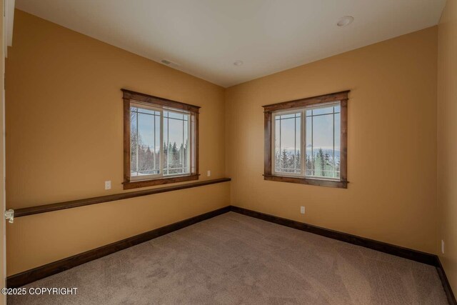 empty room with carpet and baseboards