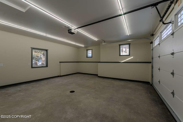 garage with a garage door opener and baseboards