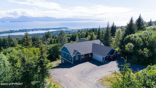 bird's eye view with a water view and a forest view