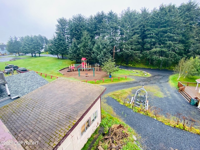 view of jungle gym featuring a yard and a wooden deck