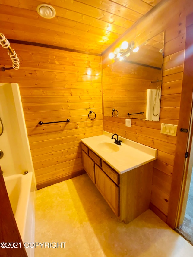 bathroom with bathtub / shower combination, wooden ceiling, wood walls, and large vanity