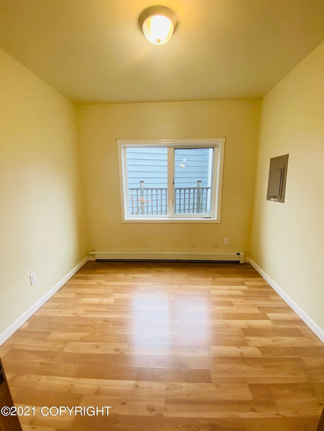 spare room with light hardwood / wood-style floors and a baseboard radiator