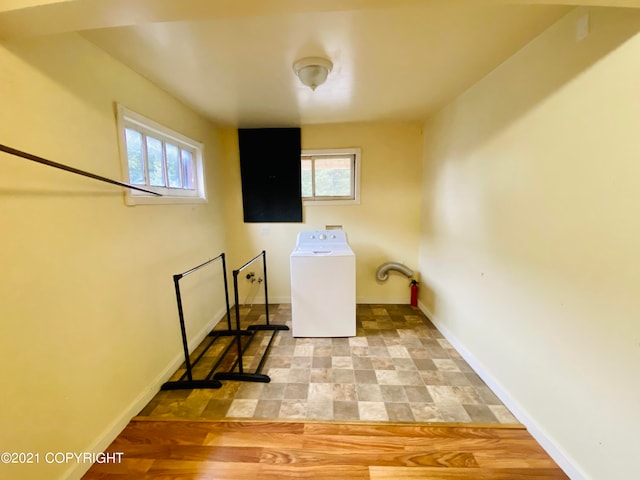 laundry room with washer / dryer and light hardwood / wood-style floors