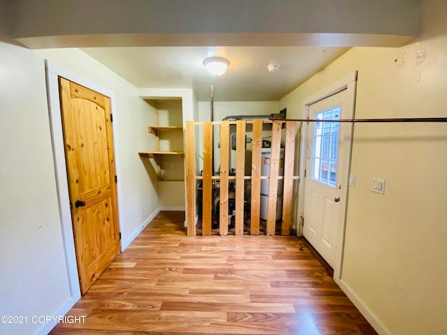 interior space with hardwood / wood-style floors and water heater