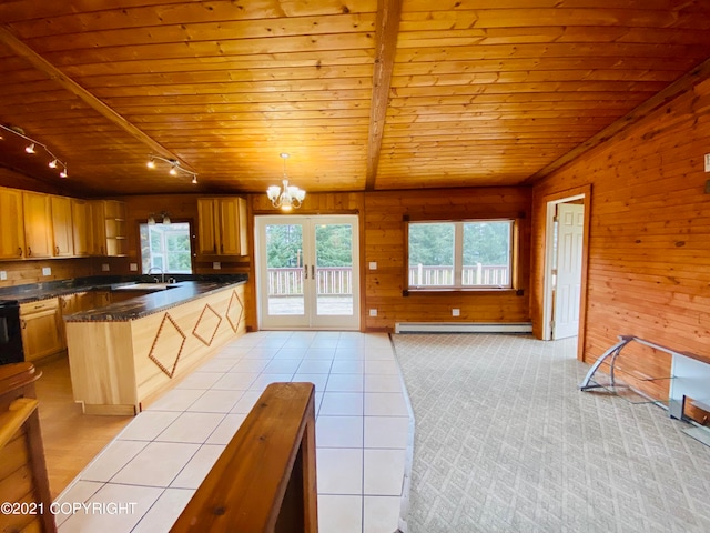 kitchen with a baseboard radiator, light carpet, pendant lighting, track lighting, and wood ceiling