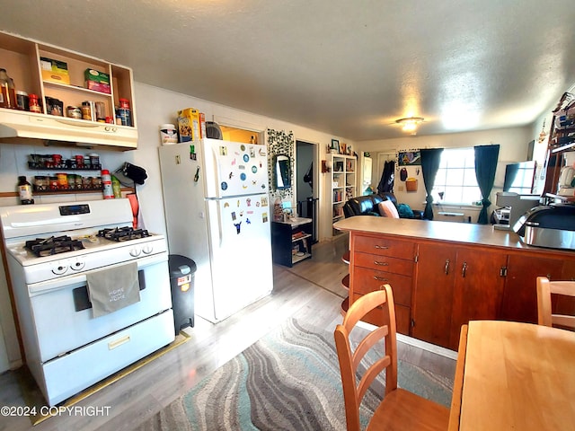 kitchen featuring white appliances and light wood-type flooring