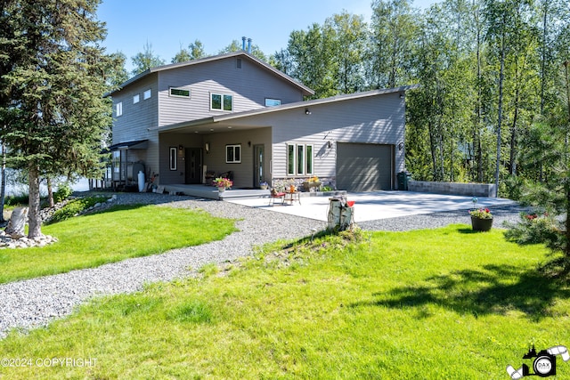 back of property featuring a yard and a garage