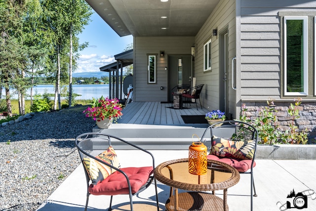 view of terrace with a deck with water view