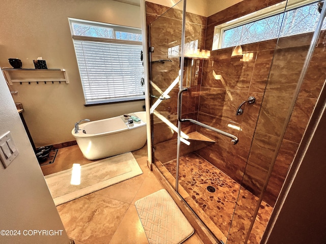 bathroom with independent shower and bath and tile flooring