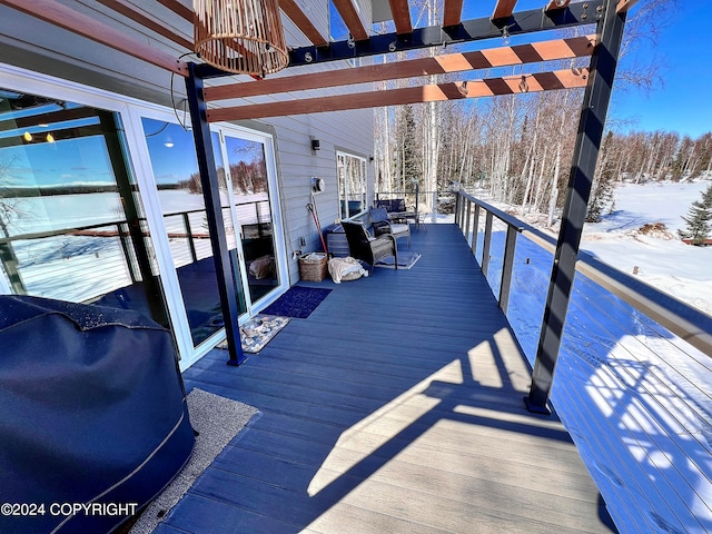 snow covered deck with a pergola