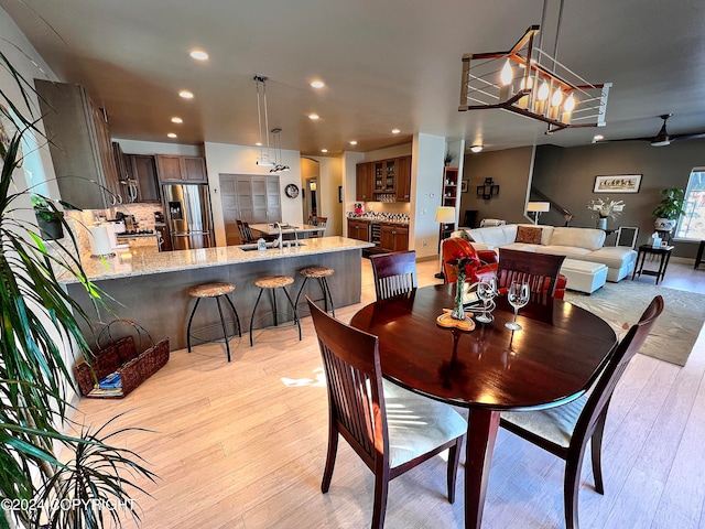 dining room with sink and light hardwood / wood-style floors