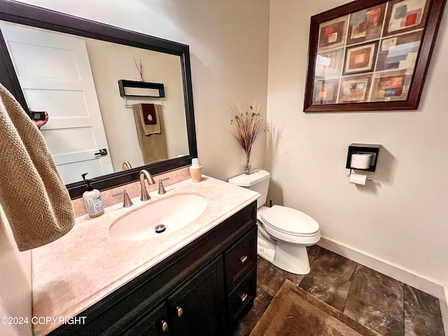 bathroom with tile flooring, vanity, and toilet