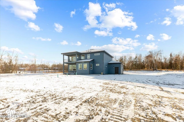 snow covered property with a balcony