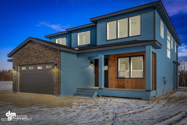 view of front of house with a porch and a garage