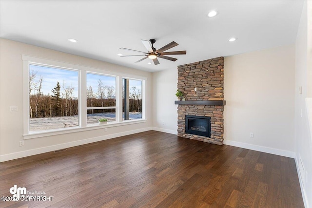 unfurnished living room with a fireplace, dark hardwood / wood-style floors, and ceiling fan