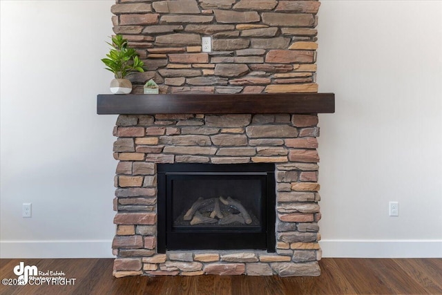 details featuring a stone fireplace and hardwood / wood-style floors