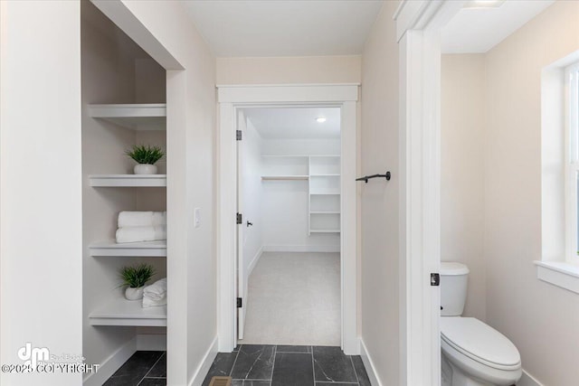 bathroom featuring built in features and toilet