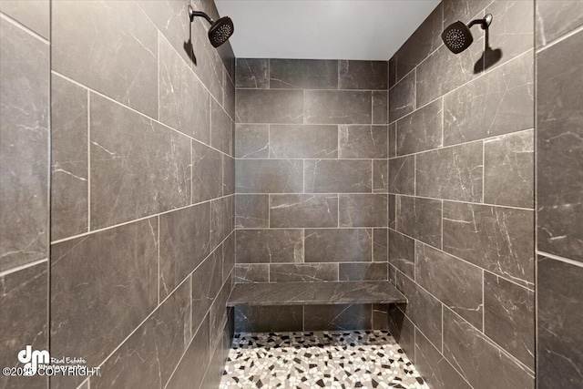 bathroom with tiled shower