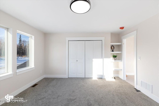 unfurnished bedroom with carpet and a closet