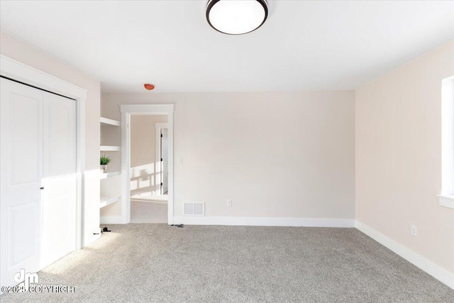 unfurnished room featuring light carpet