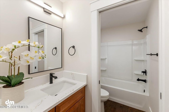 full bathroom featuring vanity, wood-type flooring, shower / washtub combination, and toilet