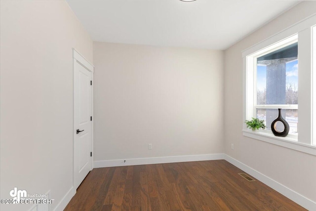 unfurnished room featuring dark hardwood / wood-style flooring