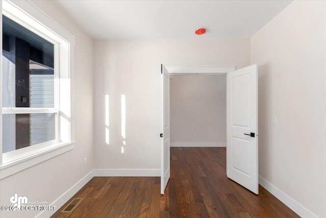 unfurnished room featuring dark hardwood / wood-style flooring