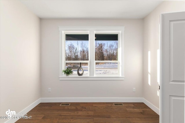 spare room with dark hardwood / wood-style flooring