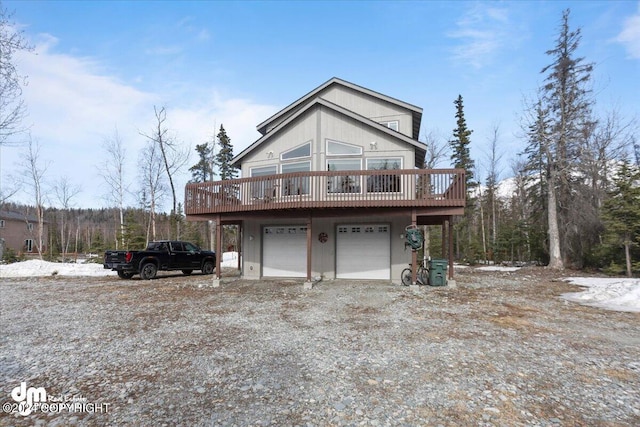 view of property exterior with a wooden deck and a garage