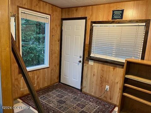 entryway featuring wood walls