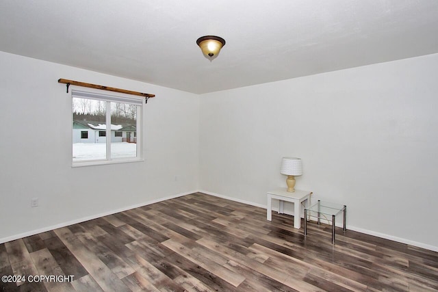 spare room featuring dark wood-type flooring