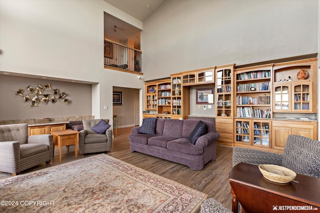 living room with high vaulted ceiling and dark hardwood / wood-style flooring