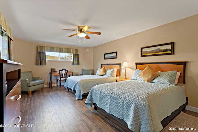 bedroom with ceiling fan and dark wood-type flooring