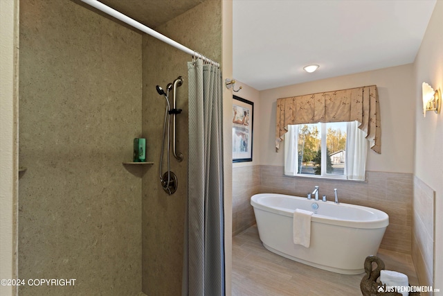 bathroom featuring tile walls and curtained shower