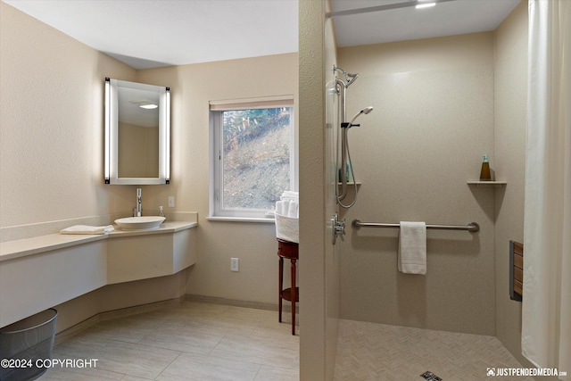 bathroom with vanity, tile patterned flooring, and tiled shower