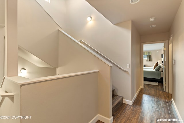 hallway with dark hardwood / wood-style flooring