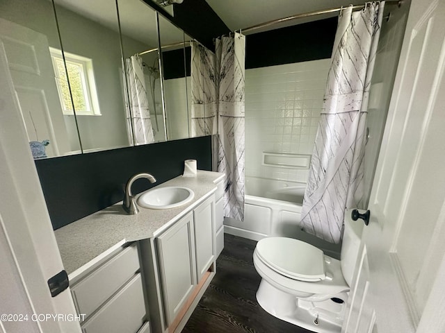 bathroom featuring shower / tub combo, toilet, wood finished floors, and vanity