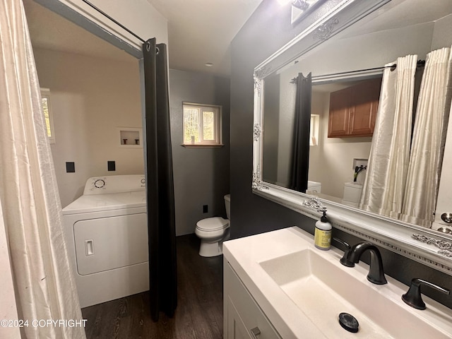 bathroom with toilet, washer / clothes dryer, vanity, and wood finished floors