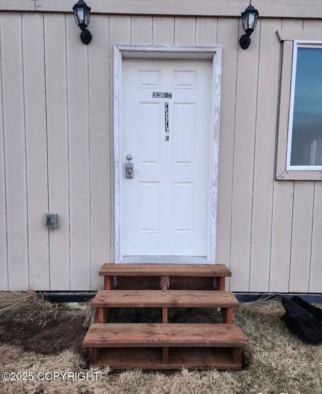 view of exterior entry featuring board and batten siding