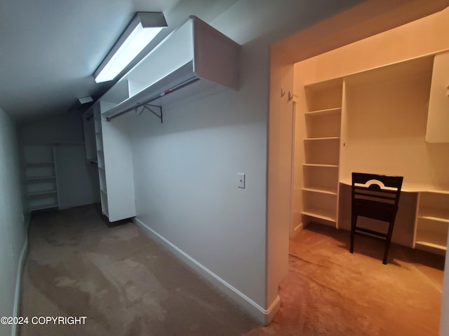 walk in closet featuring lofted ceiling and carpet floors