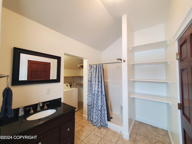 bathroom with lofted ceiling, tile patterned flooring, walk in shower, and vanity