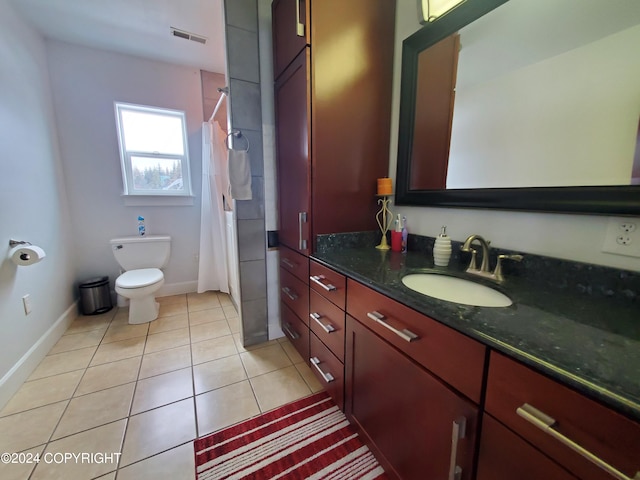 bathroom with toilet, a shower with shower curtain, vanity, and tile patterned floors