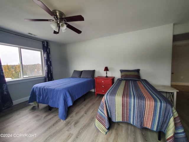 bedroom featuring ceiling fan and light hardwood / wood-style flooring