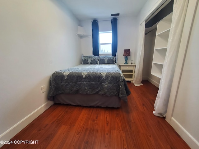 bedroom featuring dark hardwood / wood-style flooring