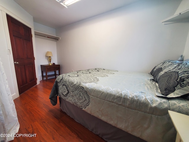 bedroom with a closet and dark hardwood / wood-style floors